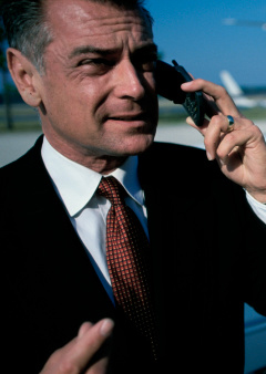 Businessman talking on a mobile phone at the airport